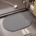 Detail of dark grey oval bath mat featuring a minimalist cat face and anti-slip texture - Gray Bear Oval (Simple Bear Oval-6)