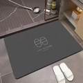 Detail view of dark grey diatomite bath mat with minimalist 'Life Attitude' typography - Gray Slippers (Simple Slippers Square-7)