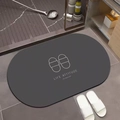 Detail of dark grey oval diatom mud bath mat with white Life Attitude typography - Gray Slippers Oval (Simple Slippers Oval-8)