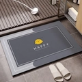 Detail of gray diatomite bath mat with yellow chick pattern and HAPPY text in bathroom - Happy Little Bird (Happy Little Bird Square-9)