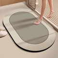 Detailed close-up of dual-color oval diatom mud bath mat with non-slip texture in modern bathroom - Straight Edge Round - Jianju Style (21) / 40x60cm (Skin-friendly Velvet) / Warm Brown Grey