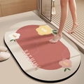 Detailed top view of oval floral bath mat with BATHING text and non-slip backing - Straight Edge Round - Huaqi Skin-Friendly Velvet / Brick Red / 40x60cm