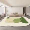 Detailed close-up of irregular faux cashmere rug with green abstract geometric patterns - Striking Multi