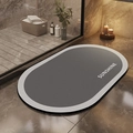 Close-up of gray oval diatomite bath mat with Sunshine text on marble floor - Wangshu Oval / 40*60cm (Skin-friendly Velvet)