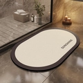Detail of oval diatom mud bath mat with SUNSHINE text in a luxury marble bathroom - Jianshu Oval / 40*60cm (Skin-friendly Velvet)