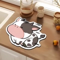 Detailed view of a cute cow shaped kitchen drying mat with black and white spots on wood - Small Cow Print