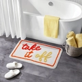 Detail of a rectangular plush bath mat with Take It Off text near a white bathtub - 822 Road-7 / 40*60cm (Skin-Friendly Surface)