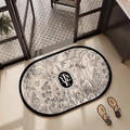 Détail du tapis en terre de diatomée vintage avec motifs botaniques et bordure noire - Terre de Diatomée / Monde Floral (Ovale)