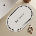 Detail of oval absorbent diatom mud bath mat with minimalist Bathroom text and black border - 40*60cm (Skin-friendly Velvet) / White