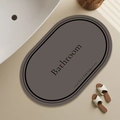 Detail of dark grey oval diatom mud mat with anti-slip texture and bathroom lettering - 40*60cm (Skin-friendly Velvet) / Coffee