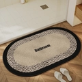 Detail view of oval bathroom mat with woven texture and artistic Bathroom text print - 40*60cm / Solid Oval Beige-1 (Skin-friendly Fleece)