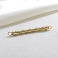 Macro detail of a gold cylindrical pendant with spiral inlaid white rhinestones and rings - Gold Spiral Connector (12)
