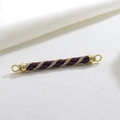 Macro view of purple enamel barrel charm with gold spiral and cubic zirconia inlay - Purple Spiral Connector (14)