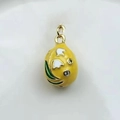 Detailed close-up of a yellow enamel egg pendant with white lily of the valley and gold trim - Yellow Lily (10)