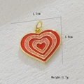 Macro shot of a 18k gold plated heart castle pendant with dimensions 1.7x1.8cm and 1.7g weight - Red Pink Gradient Heart (08)
