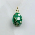 Detailed macro view of green enamel egg pendant with lily of the valley floral pattern - Emerald Lily (16)