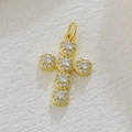 Nahaufnahme des goldenen Kreuzanhängers mit Diamantclustern und glänzenden Zirkonia-Details - Weiß