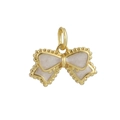 Macro detail of gold plated bow pendant with cream textured inlay and beaded edges - Cream Bow Style