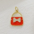 Detail of red enamel handbag charm with gold accents and sparkling crystal bowknot - Red Handbag (07)