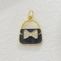 Macro detail of gold-plated handbag pendant with black enamel and zircon bow detail - Black Handbag (08)