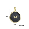 Macro detail of round 18k gold plated charm with black enamel and golden wings motif - Dark Disk Gold Wings (12)