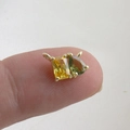 Macro view of a gold-plated pendant with square yellow and teardrop green zircon stones - Yellow Square & Green Tear Drop