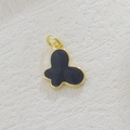 Detailed close-up of a butterfly pendant with black enamel and 18k gold-plated edges - Butterfly Black Gold Enamel (32)