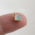 Macro detail of a square-cut light green gemstone pendant with a 18k gold-plated setting - Light Green Square Gemstone Pendant