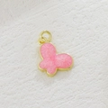 Detailed macro of pink glitter butterfly charm with gold plating for DIY jewelry making - Pink Glitter Butterfly Style