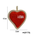 Close-up of heart-shaped 18k gold-plated pendant with LOVE embroidery and crystal border - Large Heart LOVE Embroidery (01)