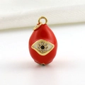 Macro detail of red enamel teardrop charm with evil eye design and zircon inlay - Red Evil Eye