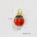 Macro view of 18k gold-plated ladybug pendant showing 1.5cm length and red enamel details - Tiny Ladybug (7)