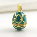 Macro detail of Peacock Blue enamel Fabergé style egg pendant with 18k gold plating - Peacock Blue Vintage Pattern Style