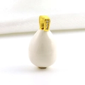 Macro shot of egg-shaped white enamel pendant with gold clasp and inset cubic zirconia - White Smooth Surface Clasp Diamond Style