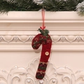 Knitted red Christmas candy cane ornament with golden wave pattern and wooden button detail - Patterned Cane