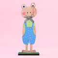Easter wooden frog figurine with plaid bow tie and colorful attire on pink background - Blue Wooden Frog Ornament