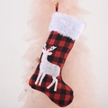 Red and black buffalo plaid Christmas stocking with white reindeer and faux fur cuff - Deer