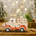 Red wooden Christmas truck ornament with snowman and green tree on a rustic table - Snowman