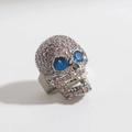 Macro shot of skull pendant with pink micro-set crystals and blue gemstone eyes - Micro Pave Pink Rhinestone Blue Eye Silver Skull (03)