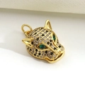 Macro detail of gold-plated leopard head pendant with micro-paved zircons and emerald eyes - Rhinestone Leopard Head (12)