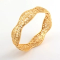 Detailopname van de 24K vergulde brede armband met fijn opengewerkt bloemmotief - Goud
