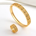 Detailed macro of gold plated jewelry set with double row green and white zircon stones - Green Zirconia Leaf Bangle And Ring