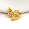 Macro detail of a gold rocking horse pendant with micro-paved zircons and a black stone eye - Dazzling Rocking Horse Style (11)