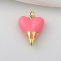 Detailed close-up of pink enamel heart pendant with golden flame-shaped metal casing - Pink