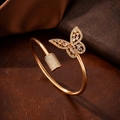 Detail of gold butterfly bracelet with pavé-set zircons on leather background - Bangle / 10427-Butterfly Bangle