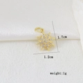 Detailed view of gold octagonal star pendant with white cubic zirconia measuring 1.7x1.2cm - Sun Starburst Style (D)