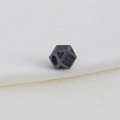 Macro shot of geometric black faceted bead with micro-pave zircons and center hole - Dice Style D
