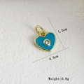 Vista macro del ciondolo a cuore in smalto blu con placcatura oro 18k e piccolo cristallo - Cuore Blu Turco (X)