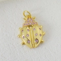 Macro shot of gold-plated ladybug pendant with sparkling pink zircon gemstones - Pink Zircon Ladybug Style (03)