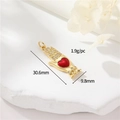 Macro view of a 18k gold plated hand holding a red heart pendant with zircon details - Hand with Red Heart (42)